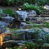 Kichler path lights encourage progression along this garden's stone stairway.